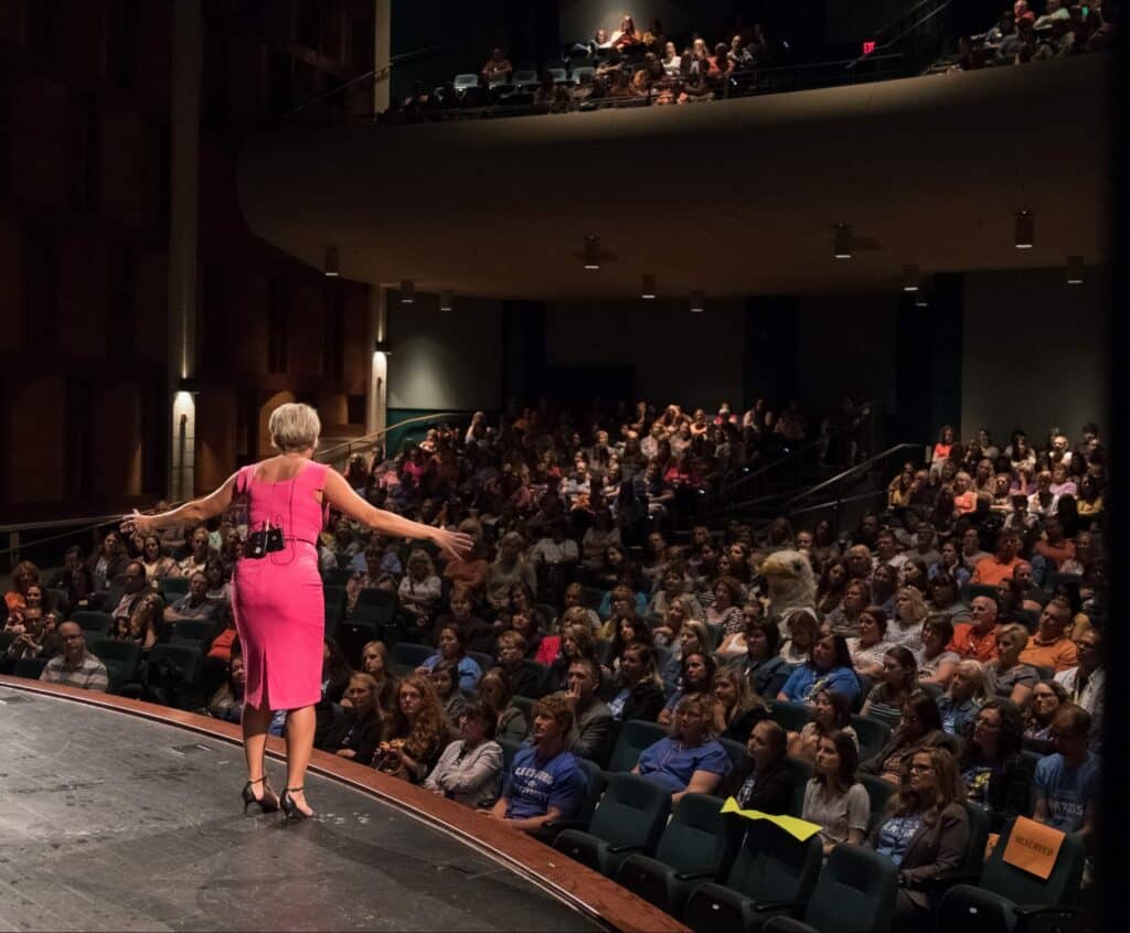 Kim Strobel Speaking In front a massive crowd