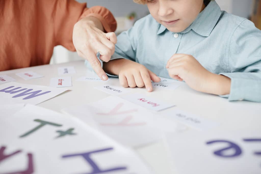 Mother helping boy learn to read at home