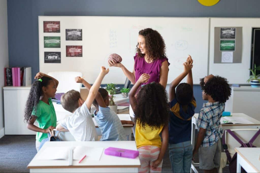 Interactive classroom activities with a teacher engaging enthusiastic children.