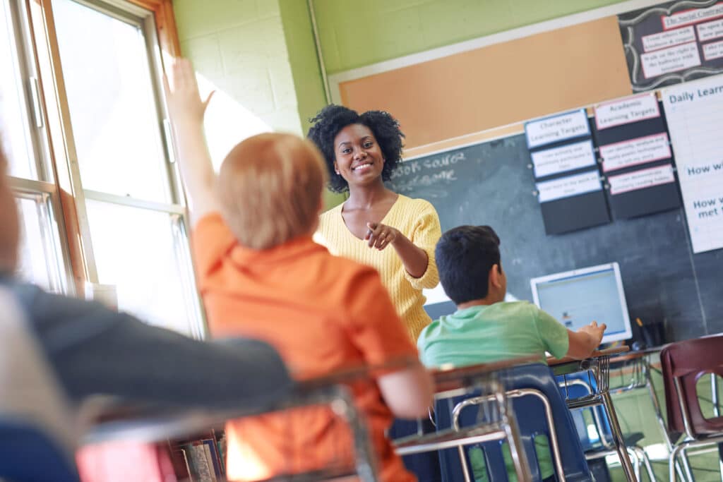 Dont be afraid to be wrong. Teacher pointing to student raising hand