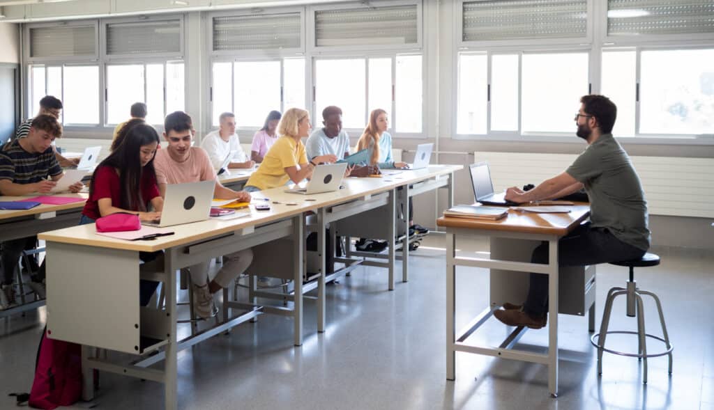 Group of diverse teenage students and a male teacher in class. highschool back to school. High quality photo