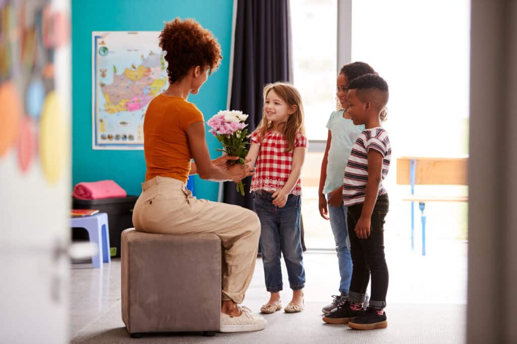 Group Of Elementary School Pupils Giving a Teacher Appreciation Week gift