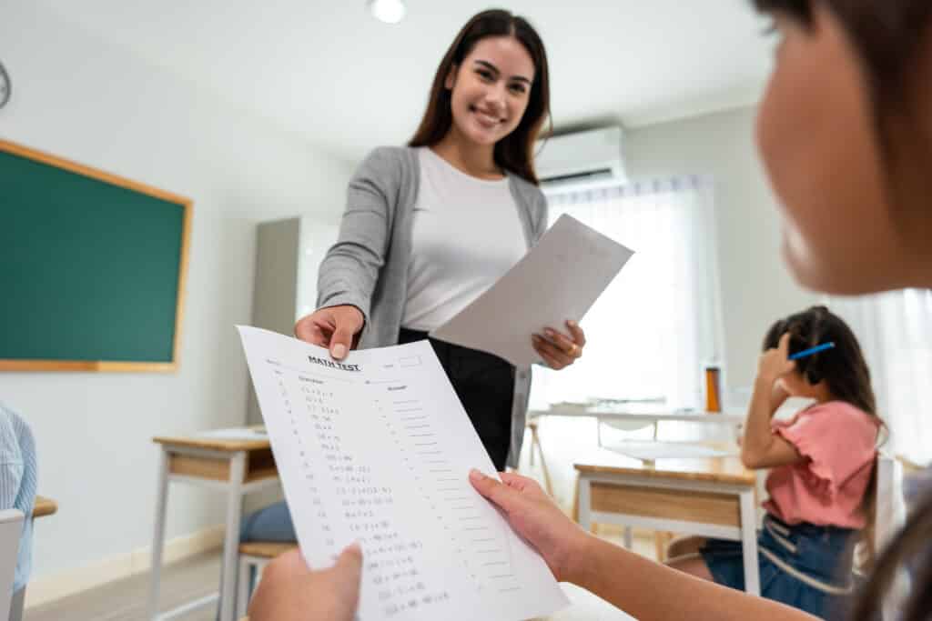 Group of student learn with teacher in classroom at elementary school.