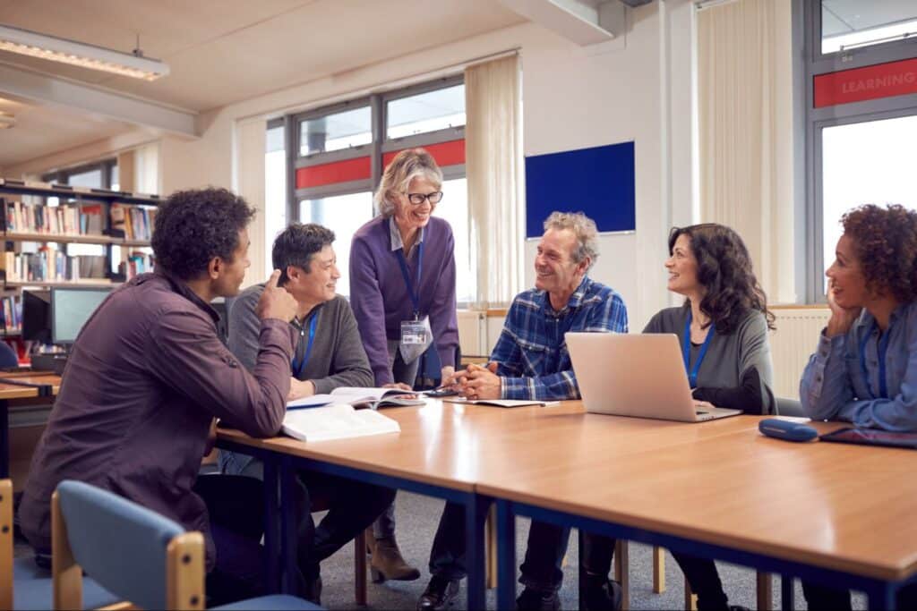 Team collaborating on data insights during a productive meeting around a table.