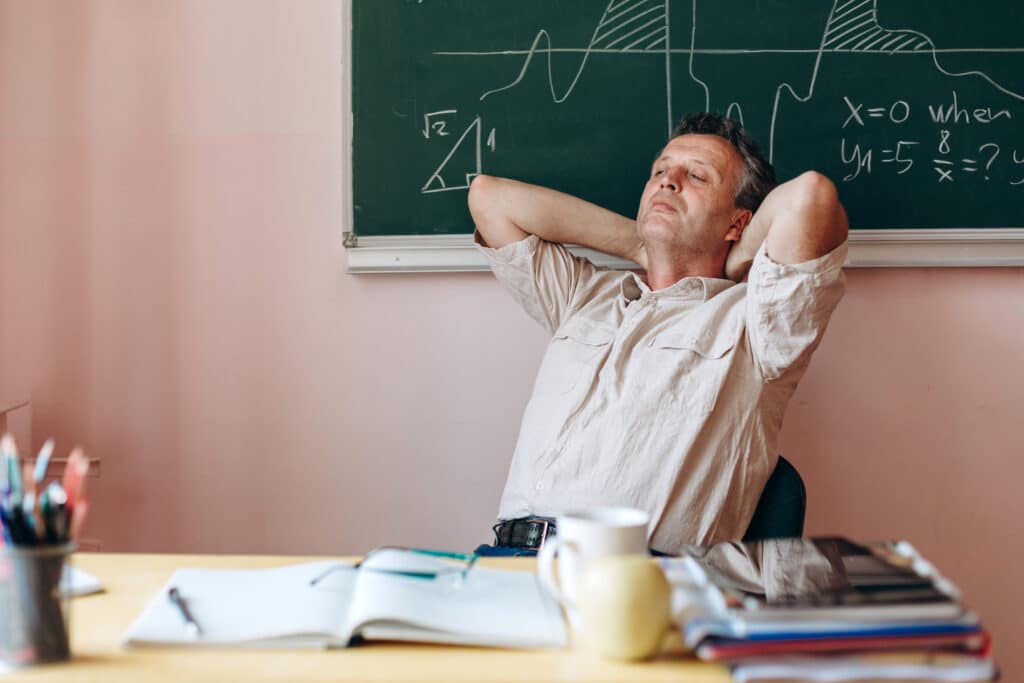 Male teacher taking a moment to rest in between classrooms