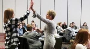 Kim giving an educator a high five