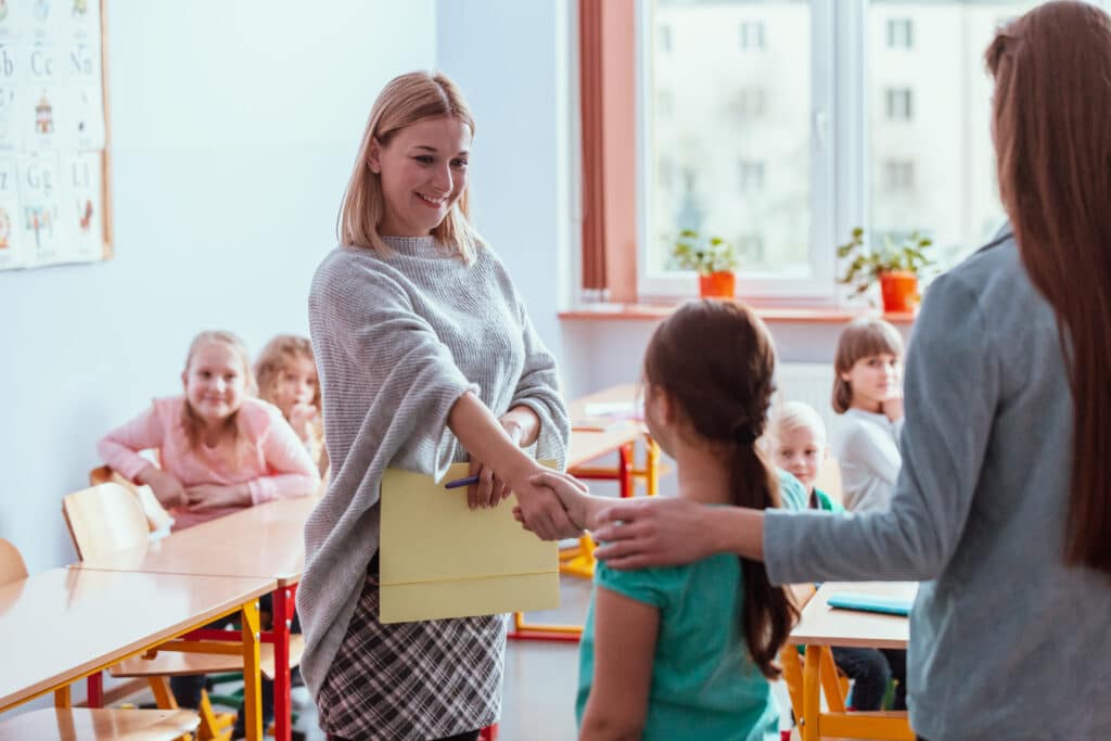 student and her parent expressing gratitude to a teacher how gratitude impacts your brain concept