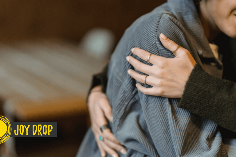 a person hugging a nother to show support