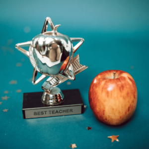 Best teacher trophy and an apple.