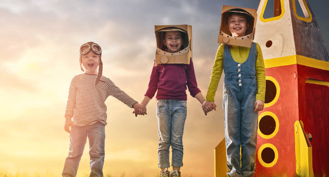 three kids with a spaceship background