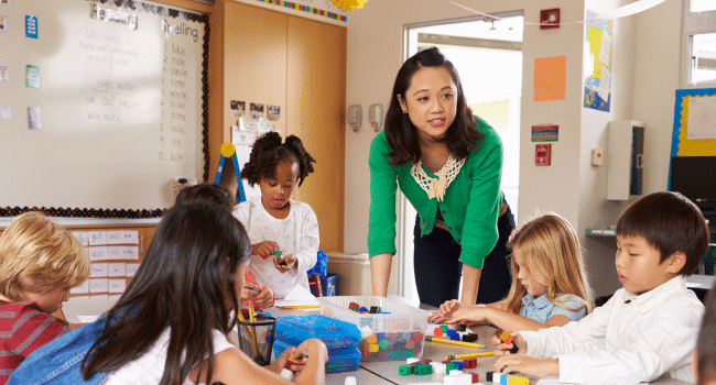 asian teacher looking after the students