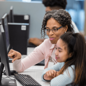 teacher and students in front of computer