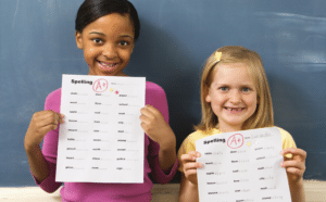 2 kids showing their grades