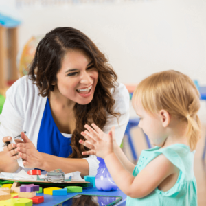 teacher praising kid or toddler for the activity