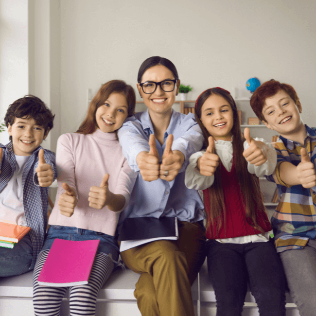 happy teacher with students showing thumbs up - science of reading