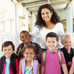 teacher with curly hair together with her stuudents