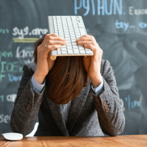 teacher feeling stressed holding a computer keyboard