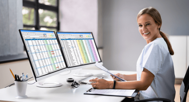 Teacher analyzing data in a computer.