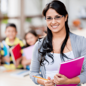 teacher holding papers on her arm