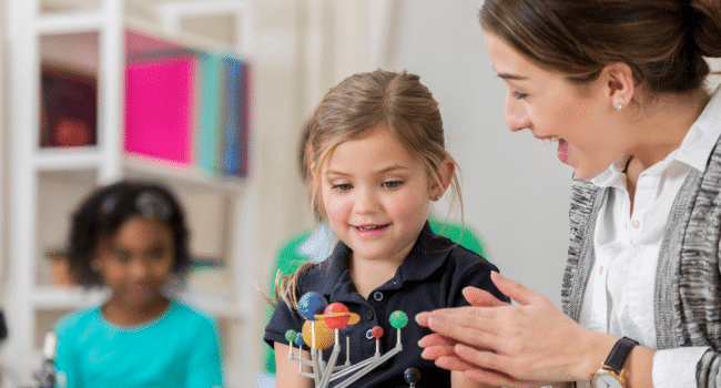 teacher praising girl student