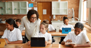 teacher with student at a laptop