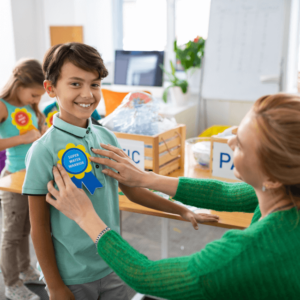 Teacher awarding her students.
