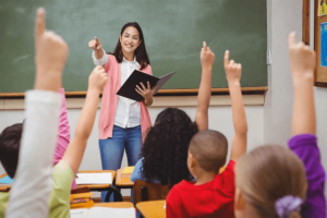 teacher with students raising hands
